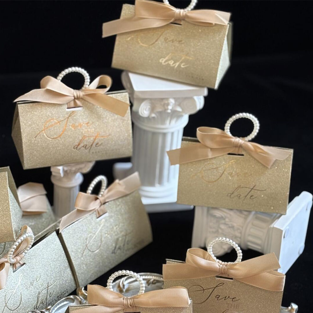 gold glitter candy favor box with pearl handle and ribbon