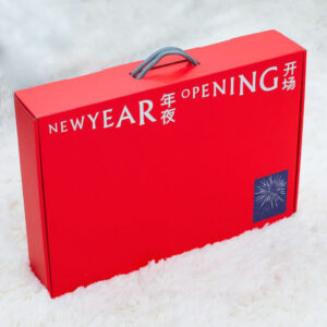 red rigid gift box with rope handle and silver foil stamping for festive holiday packaging