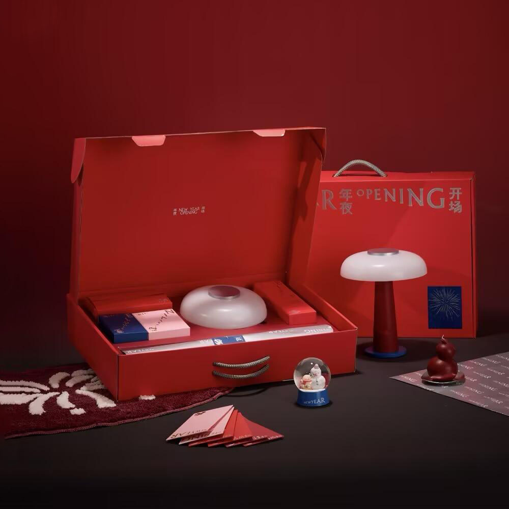 red rigid gift box with rope handle and silver foil stamping for festive holiday packaging