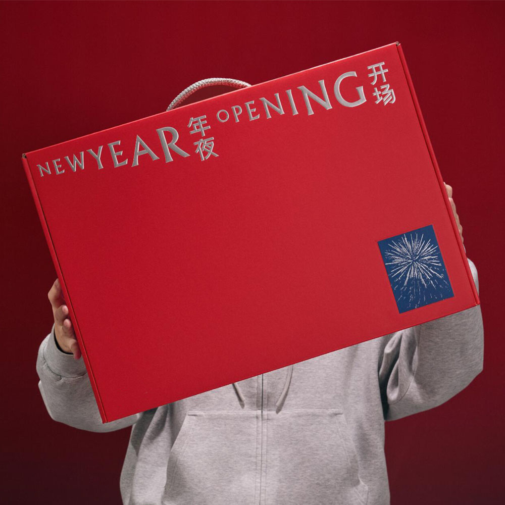 red rigid gift box with rope handle and silver foil stamping for festive holiday packaging