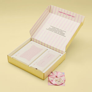 yellow folding mailer gift package box with flip lid and printed interior for clothing and lifestyle gift packaging