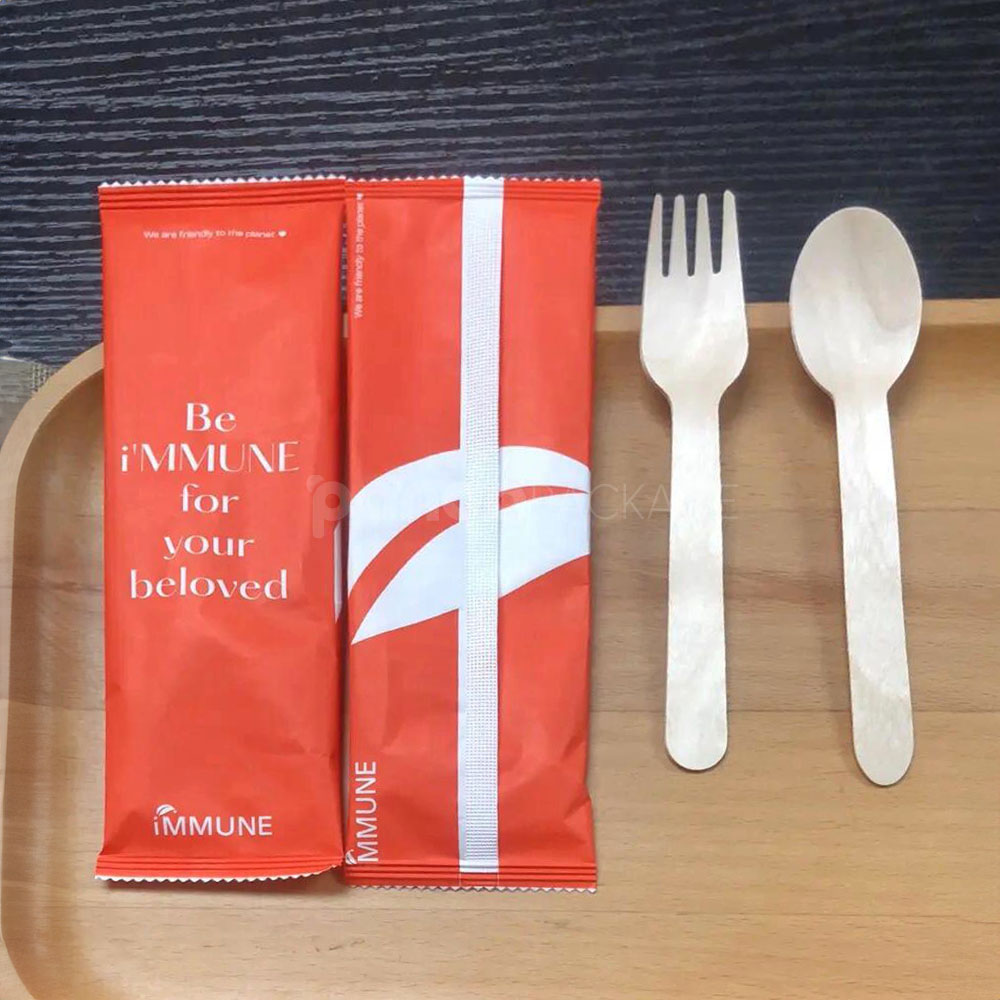 compostable wooden cutlery set with fork and spoon wrapped in paper pouch