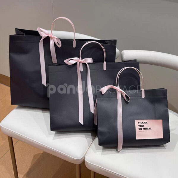 Laminated Non-Woven Tote Bags with Plastic Handles and Ribbon Bow for Apparel Packaging