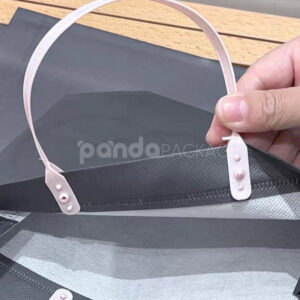 laminated non-woven tote bags with plastic handles and ribbon bow for apparel packaging in customizable colors and sizes