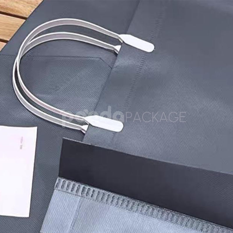 laminated non-woven tote bags with plastic handles and ribbon bow for apparel packaging in customizable colors and sizes