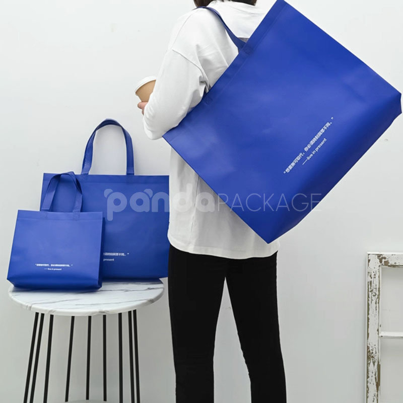 klein blue laminated non-woven tote bags with reinforced handles for apparel and retail packaging, customizable size and logo