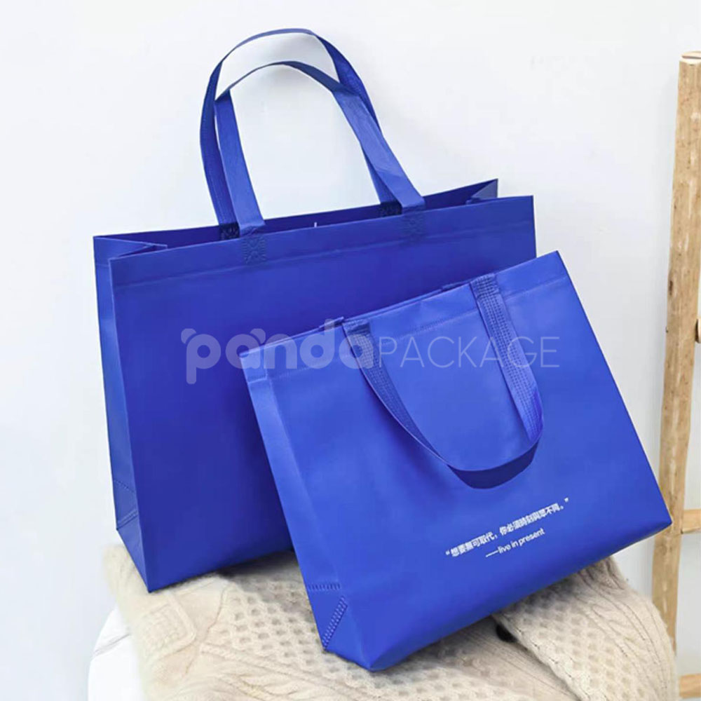 klein blue laminated non-woven tote bags with reinforced handles for apparel and retail packaging, customizable size and logo