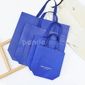 klein blue laminated non-woven tote bags with reinforced handles for apparel and retail packaging, customizable size and logo