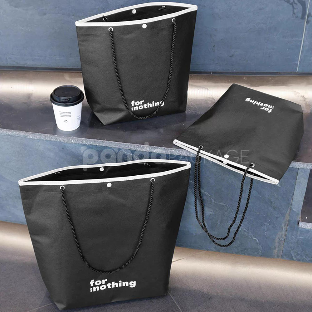 tapered non-woven tote bags with rope handles and piping edges, available in multiple colors and custom sizes for apparel packaging