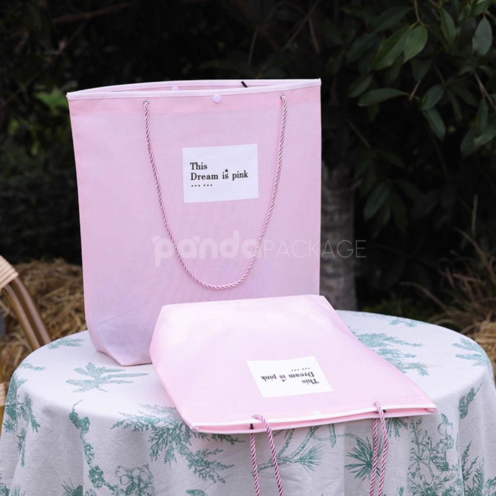 tapered non-woven tote bags with rope handles and piping edges, available in multiple colors and custom sizes for apparel packaging