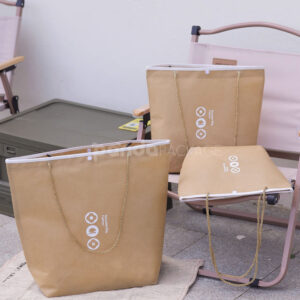 tapered non-woven tote bags with rope handles and piping edges, available in multiple colors and custom sizes for apparel packaging