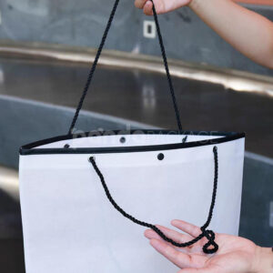 tapered non-woven tote bags with rope handles and piping edges, available in multiple colors and custom sizes for apparel packaging