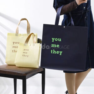 minimalist non-woven tote bags with reinforced handles and printed design, available in multiple colors and custom sizes for apparel and retail packaging