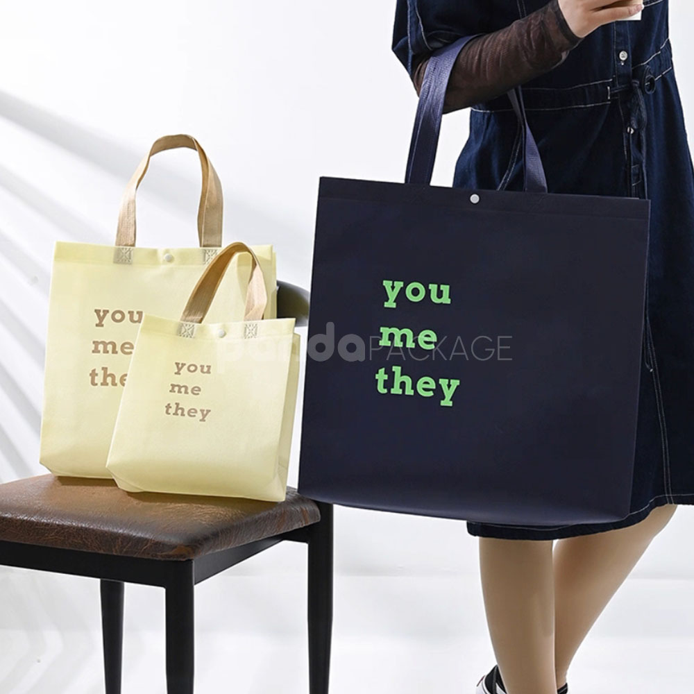 minimalist non-woven tote bags with reinforced handles and printed design, available in multiple colors and custom sizes for apparel and retail packaging