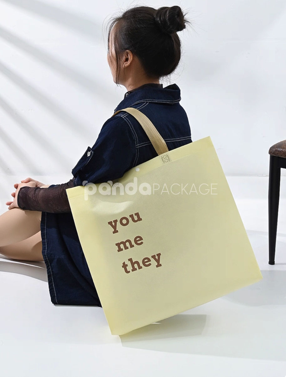 minimalist non-woven tote bags with reinforced handles and printed design, available in multiple colors and custom sizes for apparel and retail packaging