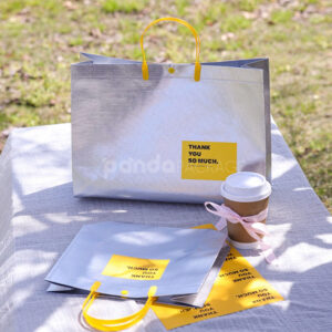 silver foil non-woven tote bags with fabric or plastic handles, customizable for apparel and gift packaging