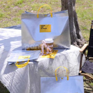 silver foil non-woven tote bags with fabric or plastic handles, customizable for apparel and gift packaging