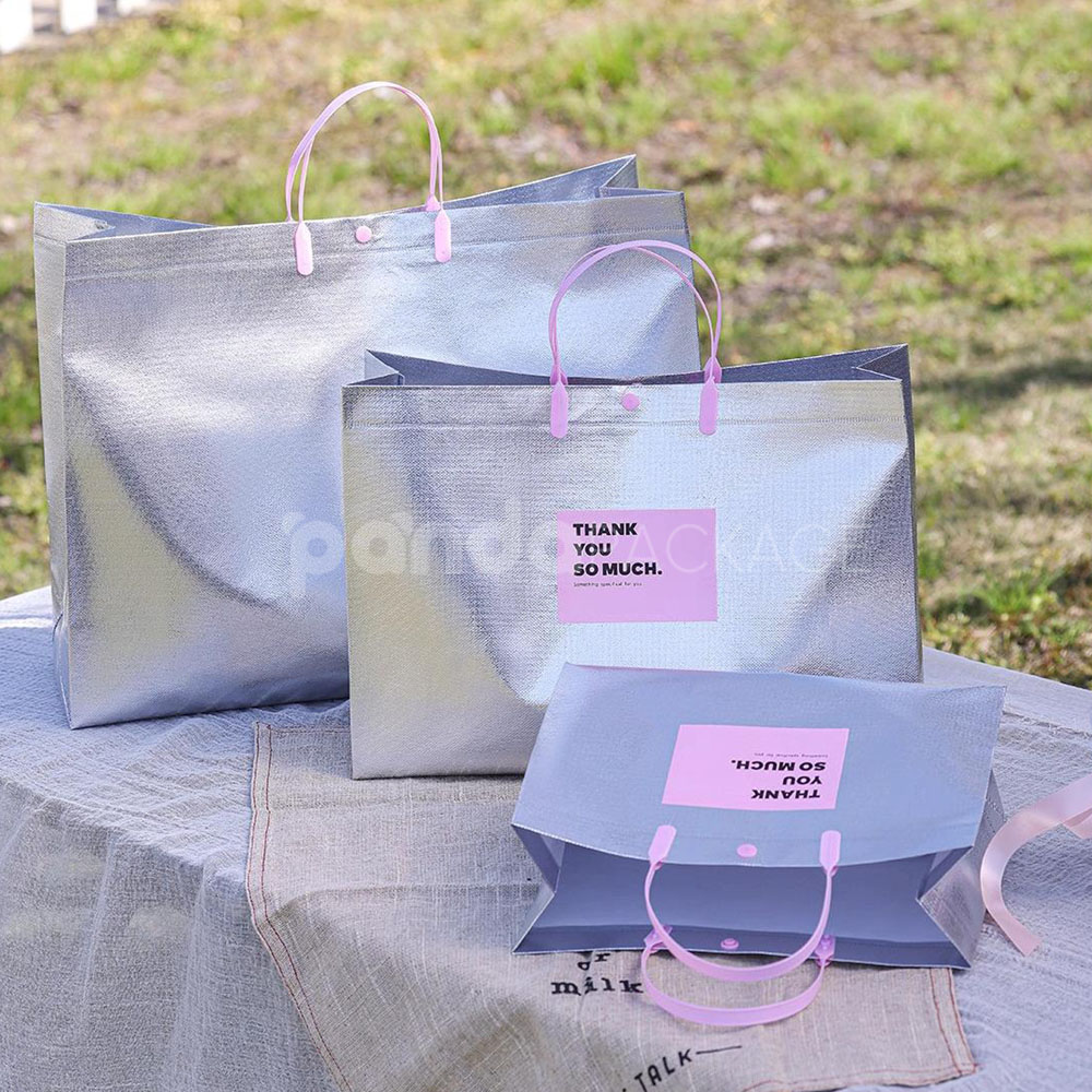 silver foil non-woven tote bags with fabric or plastic handles, customizable for apparel and gift packaging