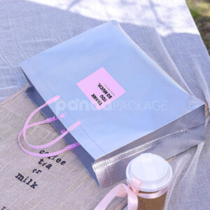 silver foil non-woven tote bags with fabric or plastic handles, customizable for apparel and gift packaging