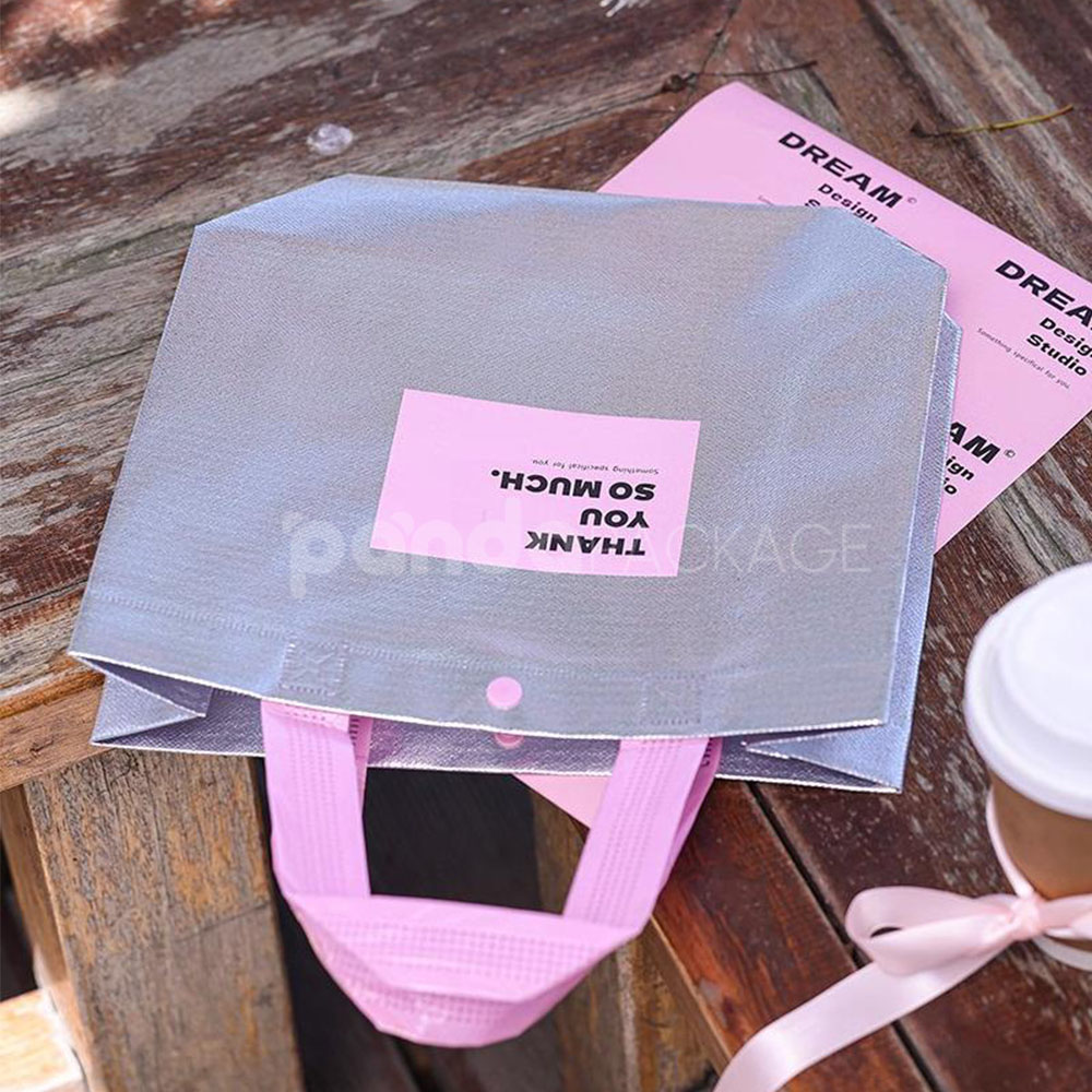 silver foil non-woven tote bags with fabric or plastic handles, customizable for apparel and gift packaging