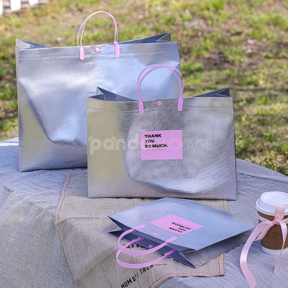silver foil non-woven tote bags with fabric or plastic handles, customizable for apparel and gift packaging