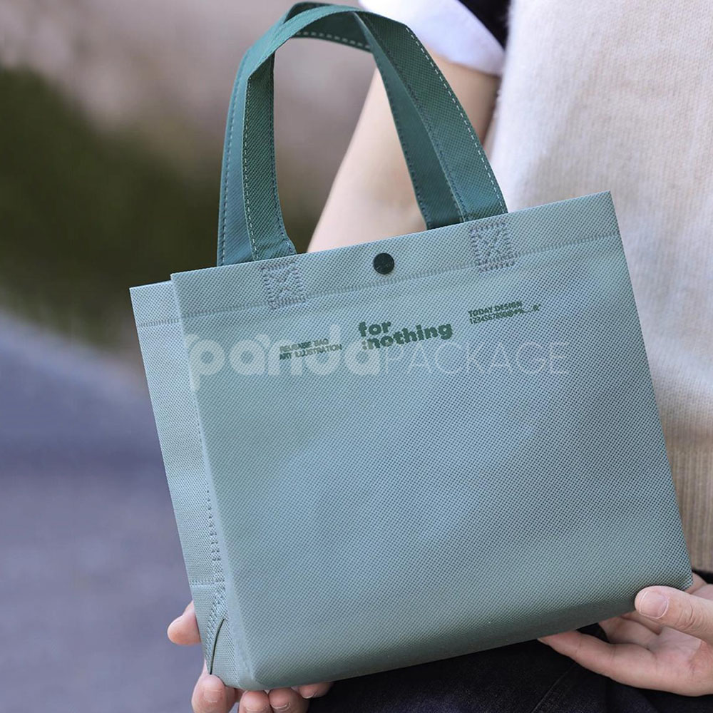 thickened non-woven tote bags with reinforced handles and snap button closure, custom printed for apparel and retail packaging