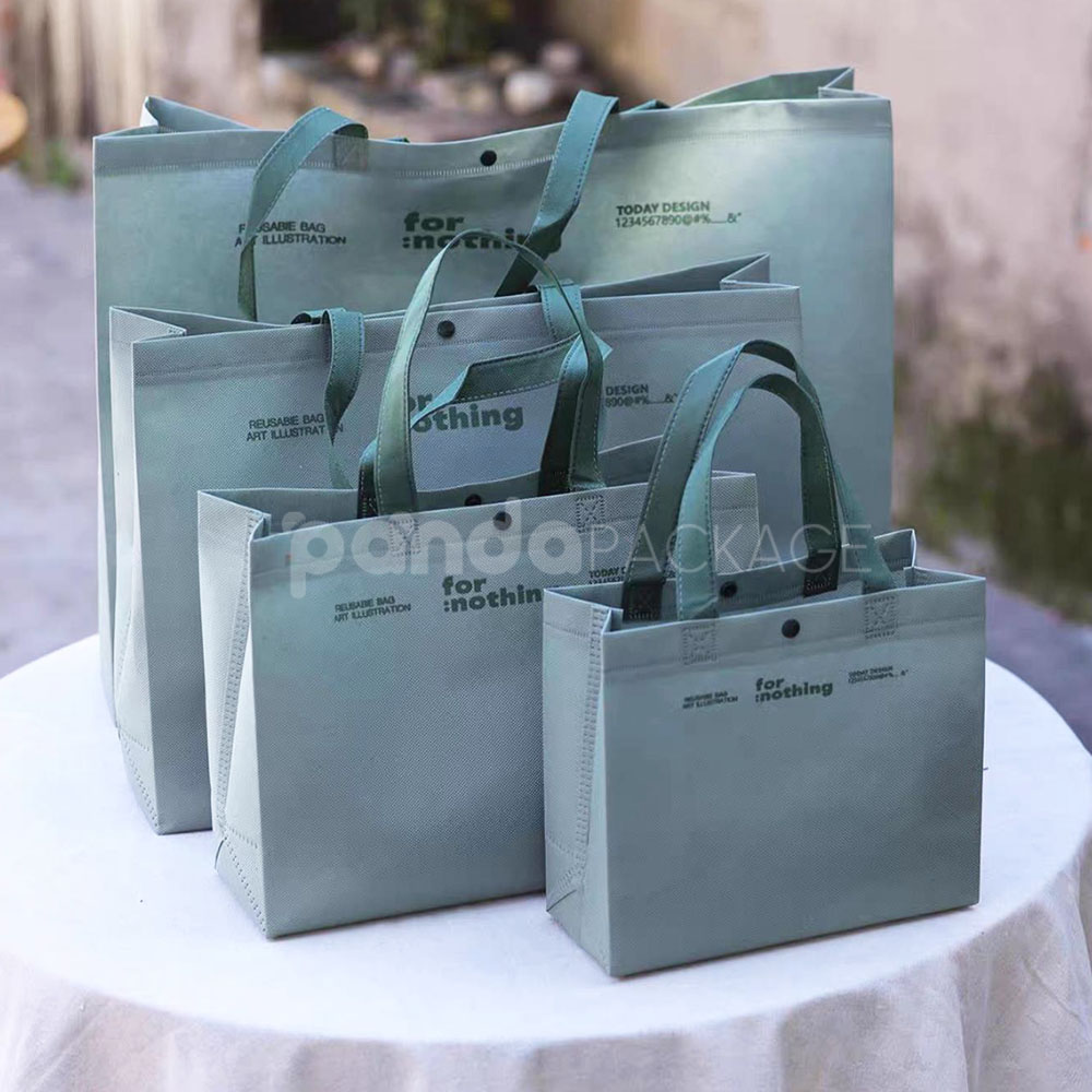 thickened non-woven tote bags with reinforced handles and snap button closure, custom printed for apparel and retail packaging