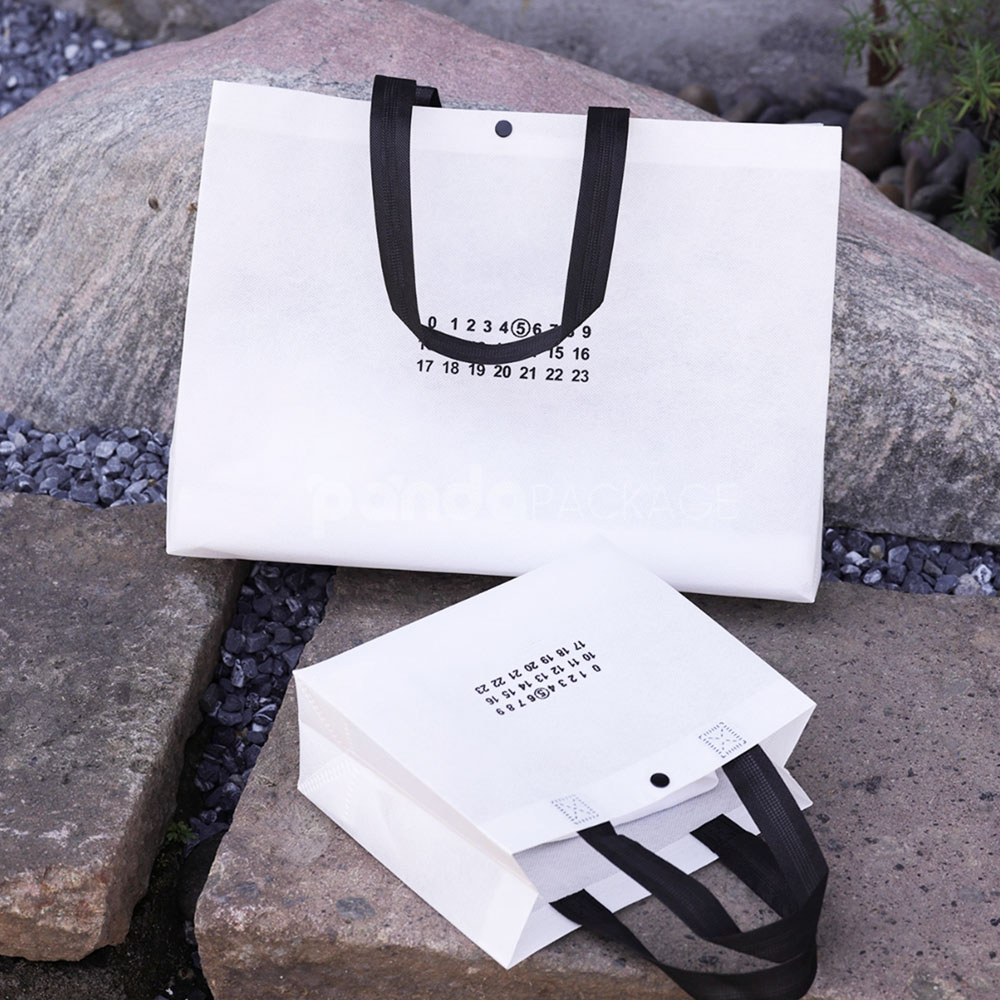 thickened non-woven tote bags with reinforced handles and snap button closure, custom printed for apparel and retail packaging