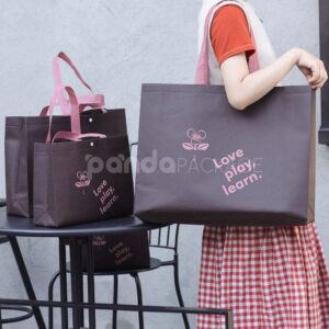 thickened non-woven tote bags with reinforced handles and snap button closure, custom printed for apparel and retail packaging