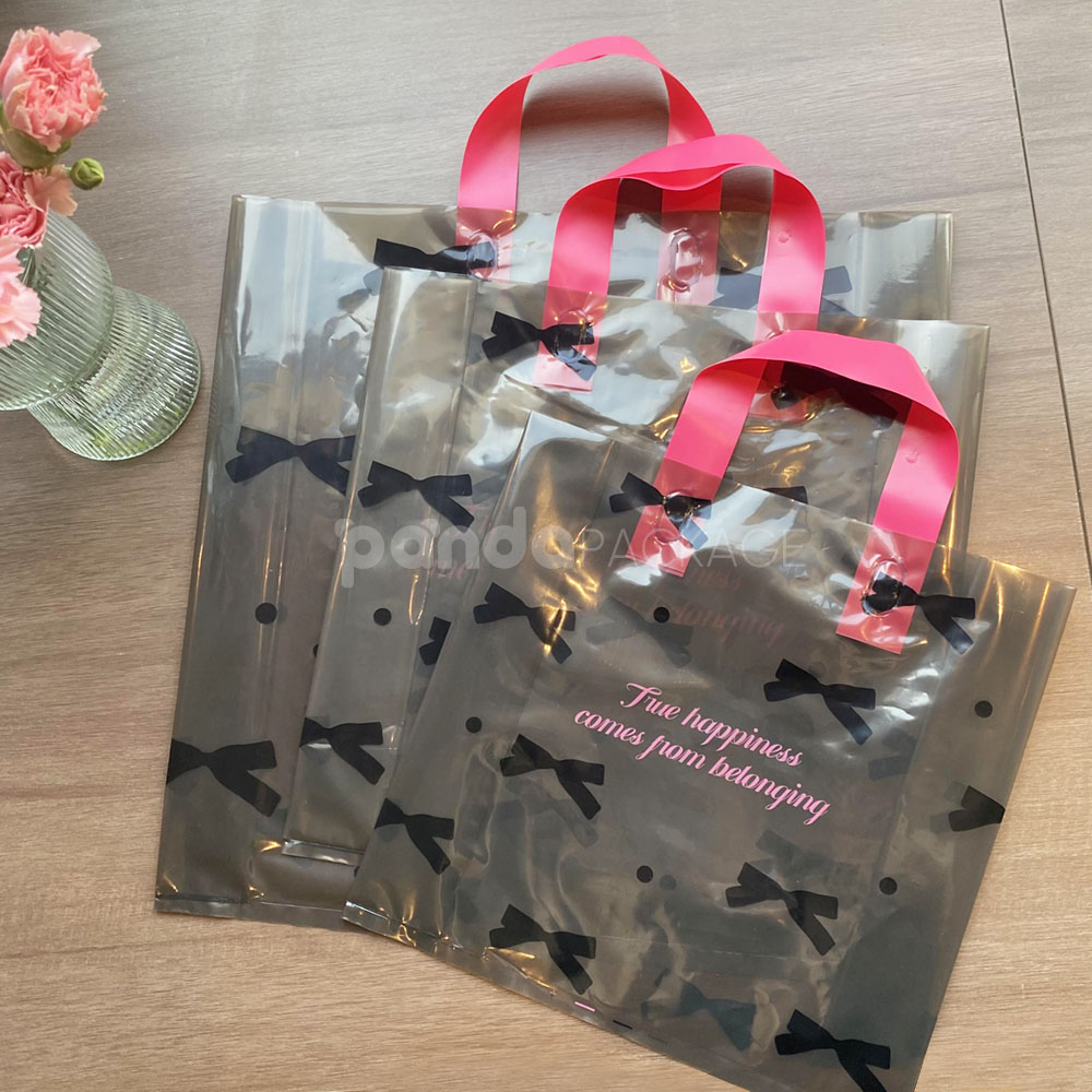 two-tone transparent plastic shopping bag with pink handles for clothing packaging
