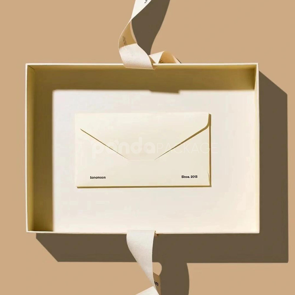 ivory rigid gift box with ribbon and matching paper bag for luxury product packaging