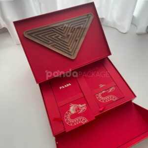 luxury magnetic flip lid rigid box with red textured surface and gold logo plaque for premium gift packaging