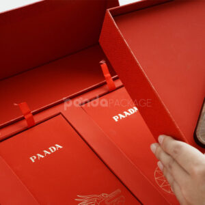 luxury magnetic flip lid rigid box with red textured surface and gold logo plaque for premium gift packaging
