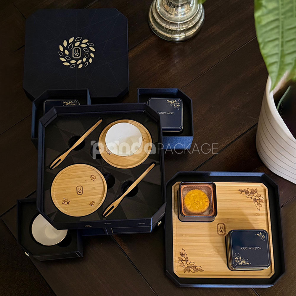 luxury octagonal rigid gift box in royal navy blue with gold foil logo, matching paper bag, and multi-drawer design for premium gifting