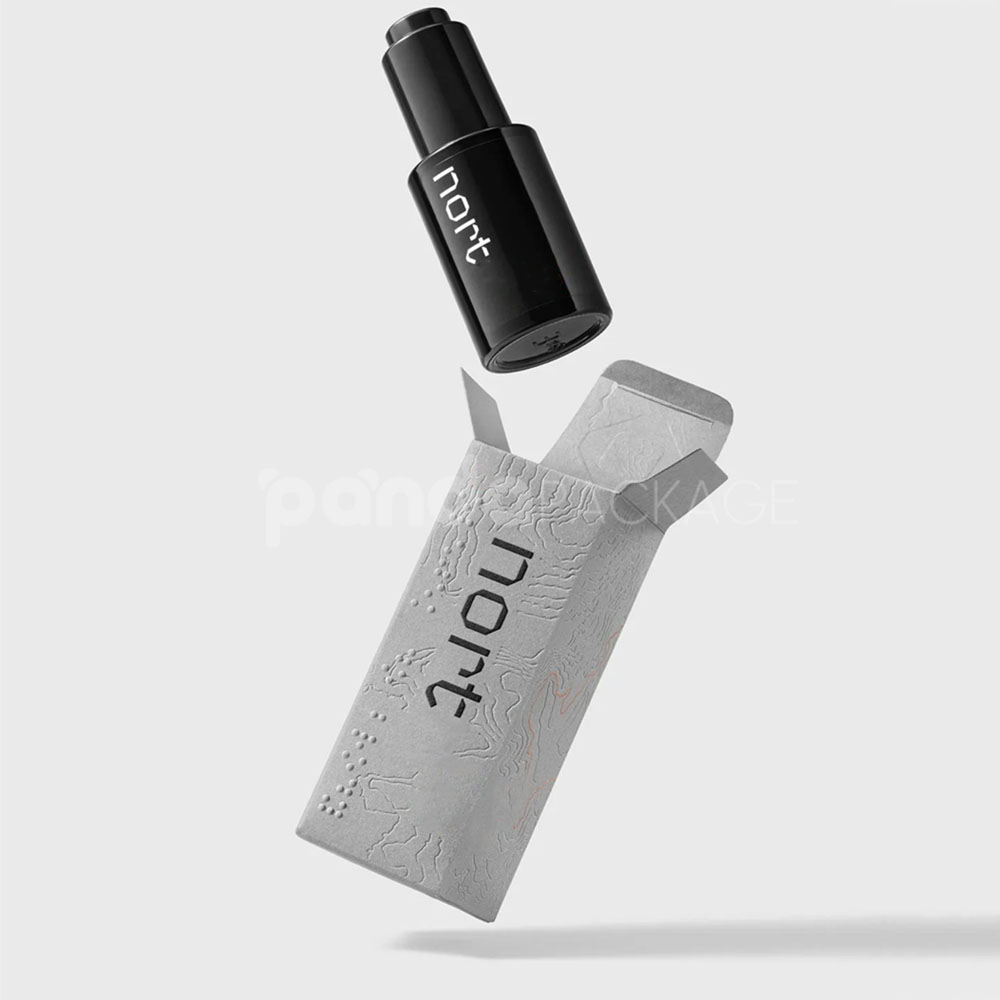 luxury textured grey paperboard box for skincare packaging with embossed terrain pattern and orange foil line details