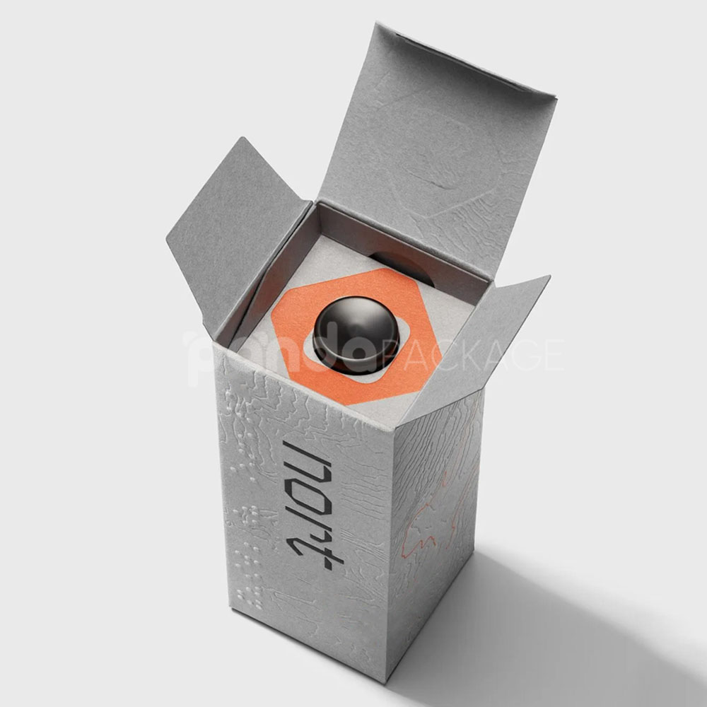luxury textured grey paperboard box for skincare packaging with embossed terrain pattern and orange foil line details