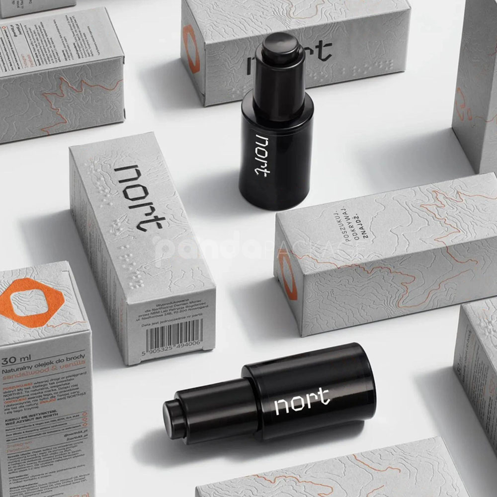 luxury textured grey paperboard box for skincare packaging with embossed terrain pattern and orange foil line details