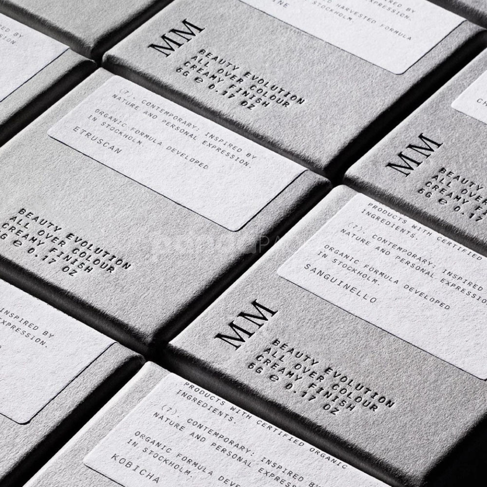 sustainable minimalist cosmetic packaging box made from recyclable paperboard with embossed typography and natural color finish