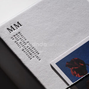 sustainable minimalist cosmetic packaging box made from recyclable paperboard with embossed typography and natural color finish