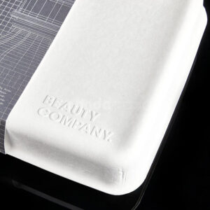 biodegradable white molded pulp skincare box with hinged lid and custom insert for sustainable cosmetic packaging