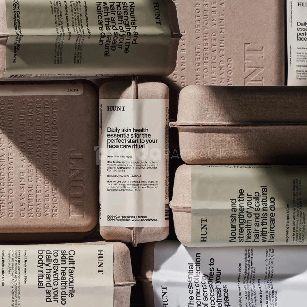 biodegradable molded pulp cosmetic box with embossed typography and printed sleeve for sustainable body care packaging