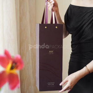 luxury burgundy rigid magnetic wine packaging box with gold foil logo and matching paper bag for single-bottle presentation