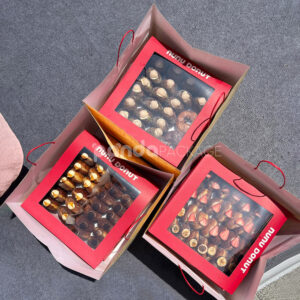 red and pale yellow paperboard donut box with clear window lid and divider grid for bakery gift packaging