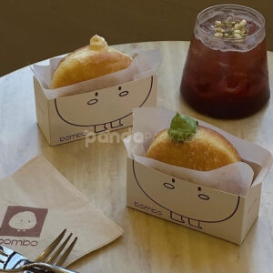 white paperboard donut tray with cute cartoon character design for bakery takeout and dessert packaging