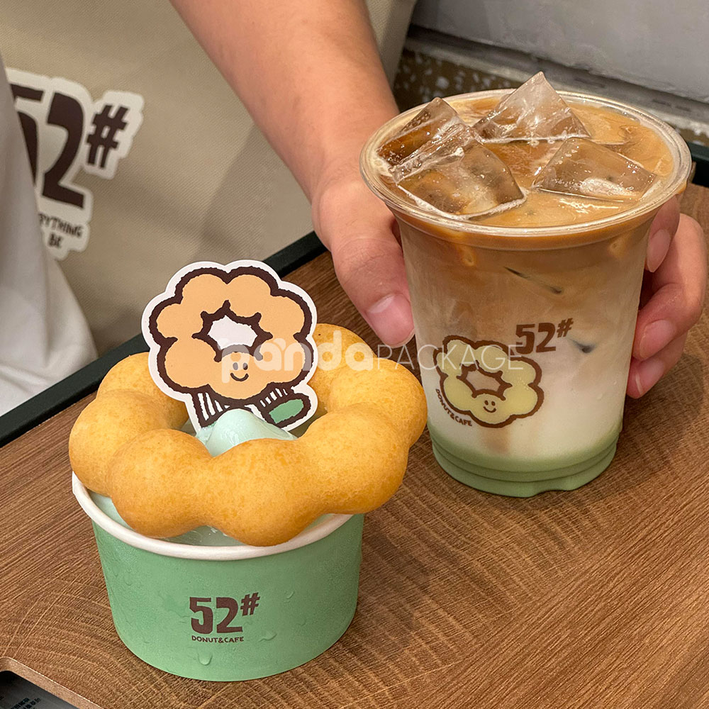 mint green paper donut cup with printed cafe logo design for bakery and dessert packaging