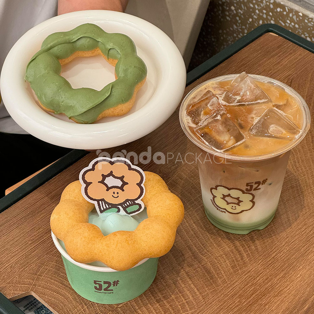 mint green paper donut cup with printed cafe logo design for bakery and dessert packaging