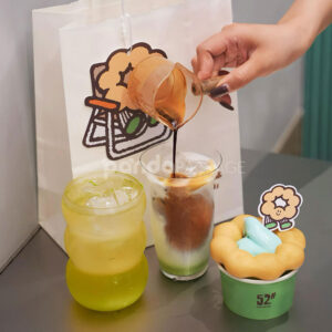 mint green paper donut cup with printed cafe logo design for bakery and dessert packaging