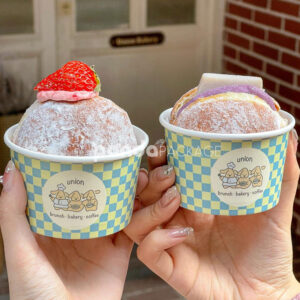 blue and yellow checkered paper donut cup with cute cartoon logo for bakery and cafe dessert packaging