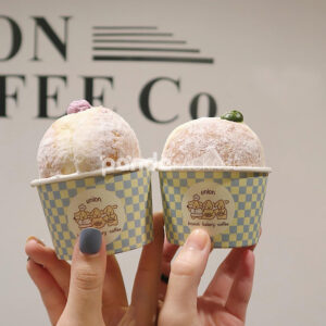 blue and yellow checkered paper donut cup with cute cartoon logo for bakery and cafe dessert packaging