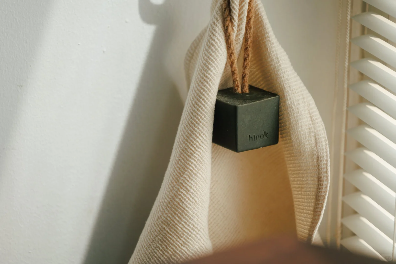 Small paper package attached to a cloth bag